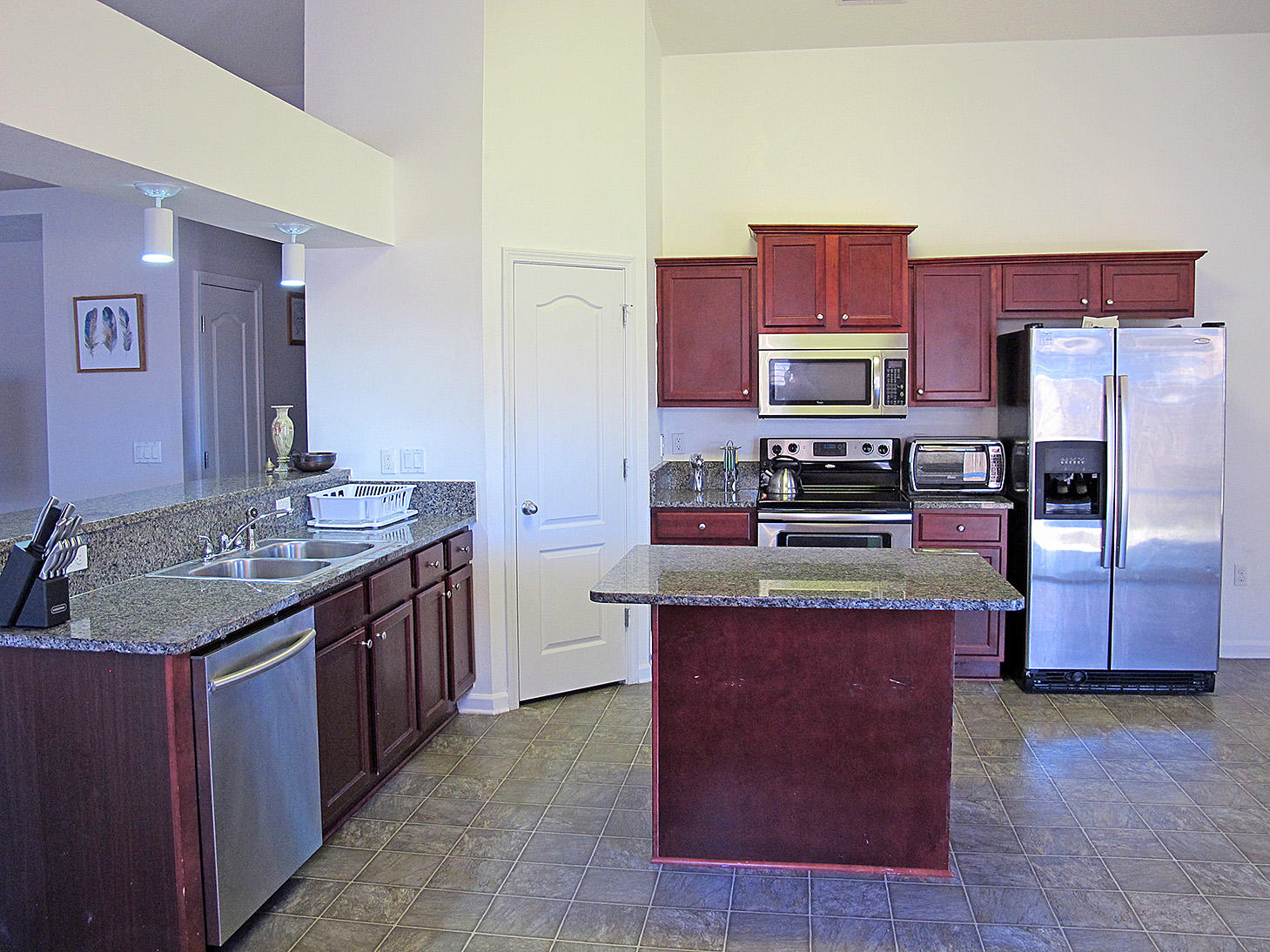 7980 Promise Creek Road Navarre, FL 32566 - Photo 12 of 31 a kitchen with stainless steel appliances granite countertop a stove a sink dishwasher a refrigerator and a oven