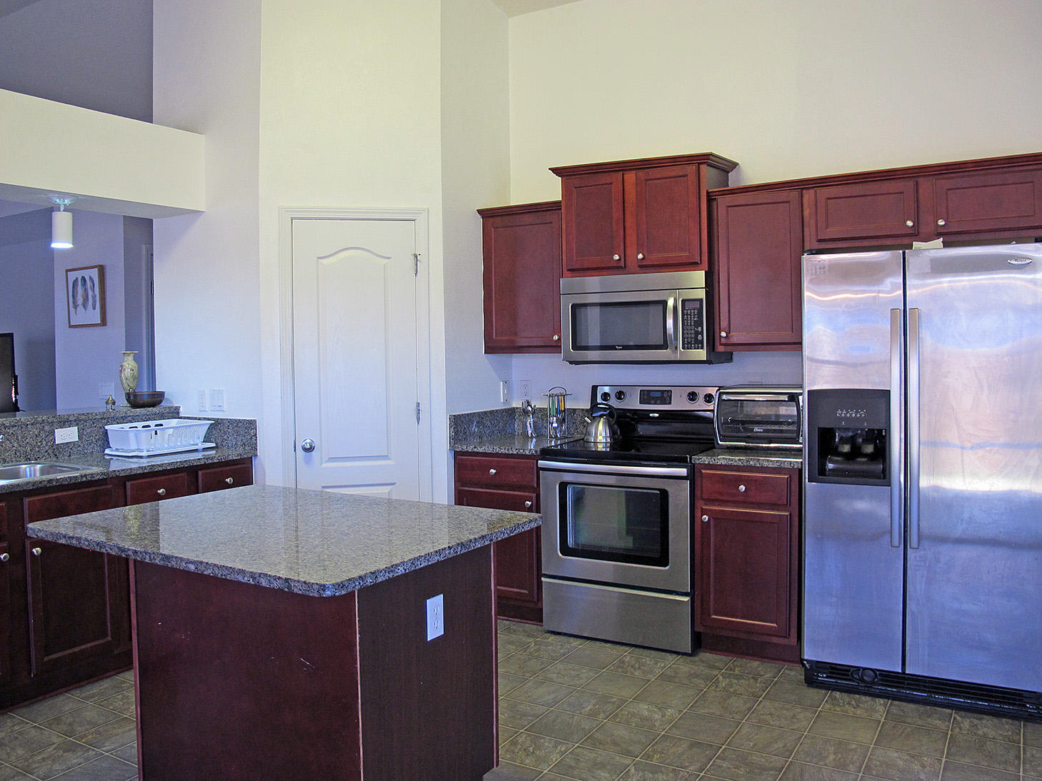 7980 Promise Creek Road Navarre, FL 32566 - Photo 13 of 31 a kitchen with stainless steel appliances granite countertop a sink stove and refrigerator