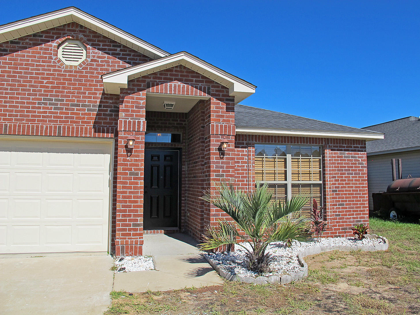 7980 Promise Creek Road Navarre, FL 32566 - Photo 3 of 31 a front view of a house with a yard