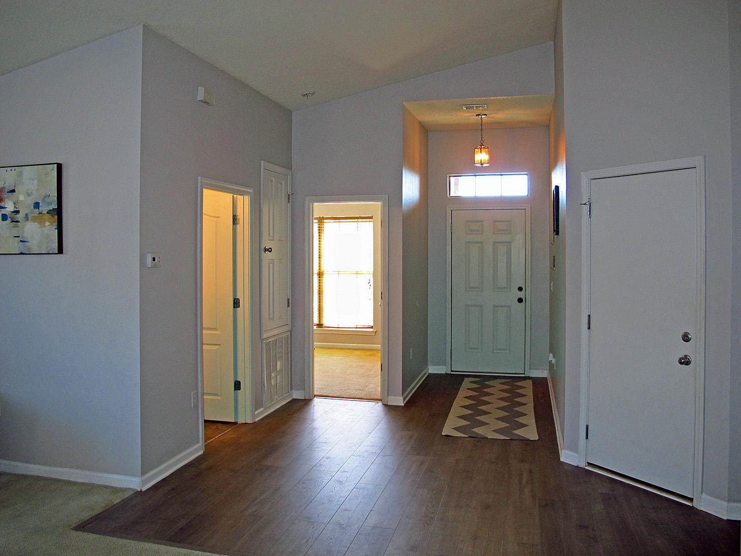 7980 Promise Creek Road Navarre, FL 32566 - Photo 5 of 31 an empty room with wooden floor and windows