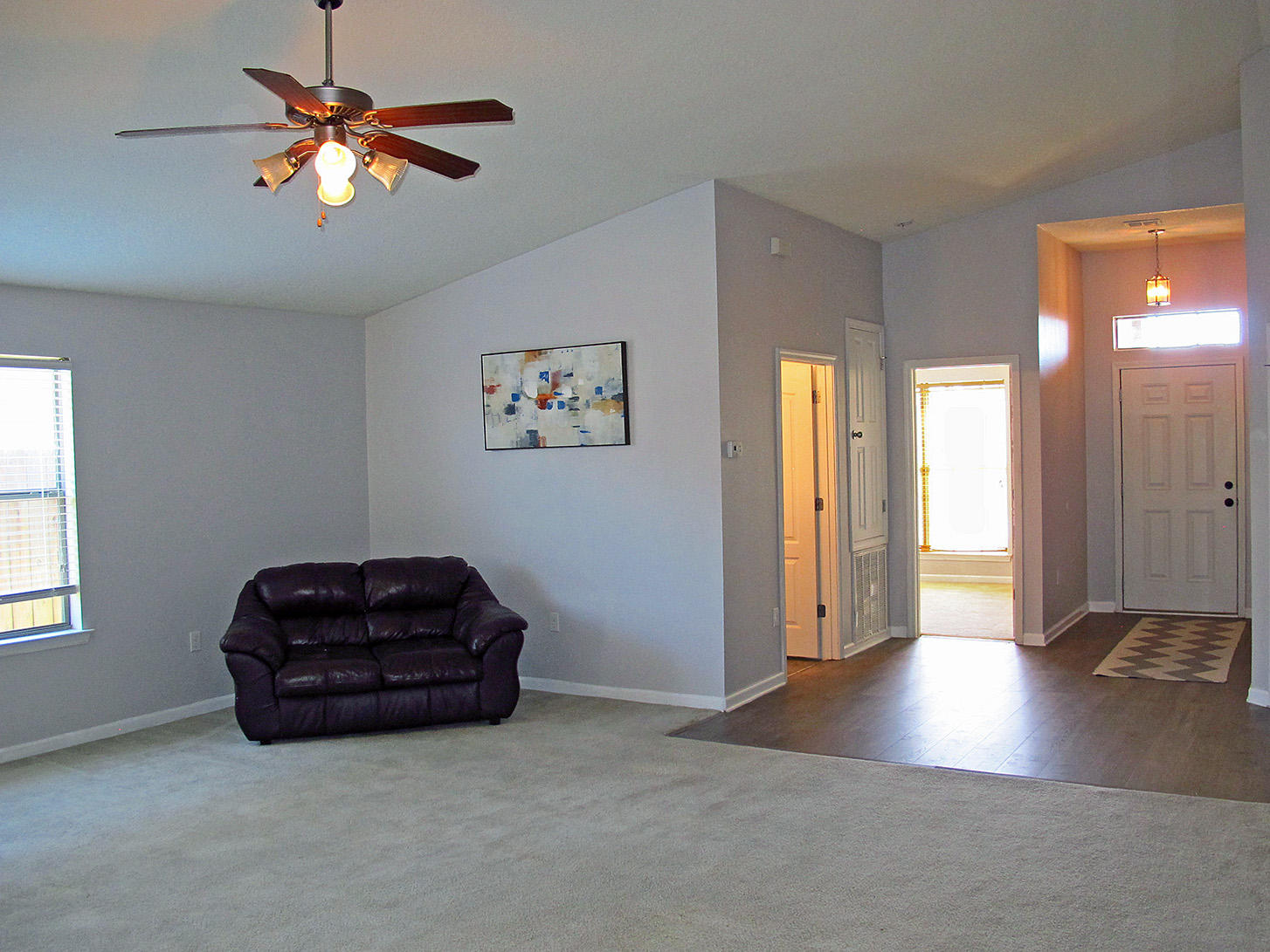 7980 Promise Creek Road Navarre, FL 32566 - Photo 6 of 31 a living room with furniture and a chandelier