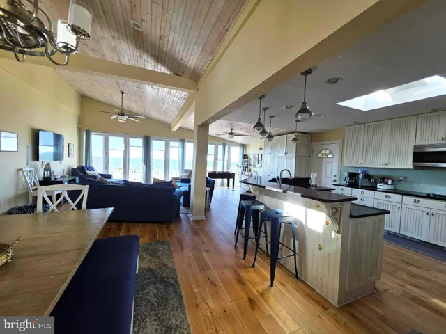 a large kitchen with lots of counter space a sink appliances and a dining table