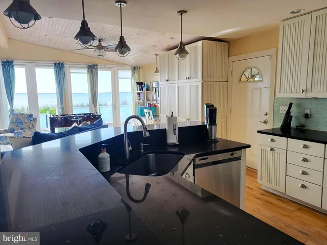 a kitchen with stainless steel appliances granite countertop a sink a stove and a refrigerator