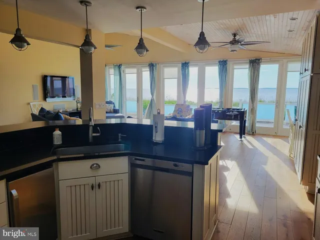 a kitchen with a sink a counter space dining table and chairs