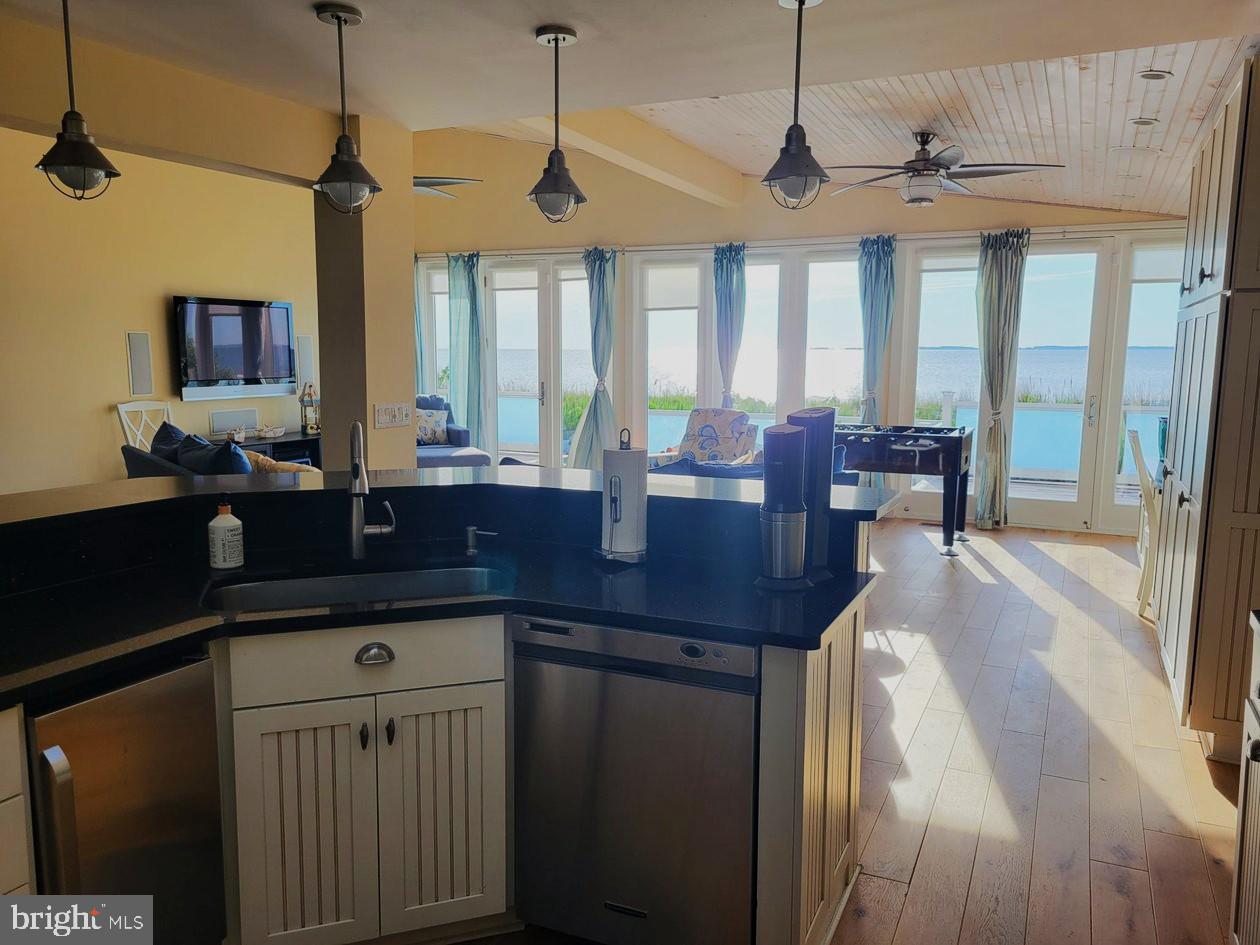 8034 Riverview Road Westover, MD 21871 - Photo 18 of 47 a kitchen with a sink a counter space dining table and chairs