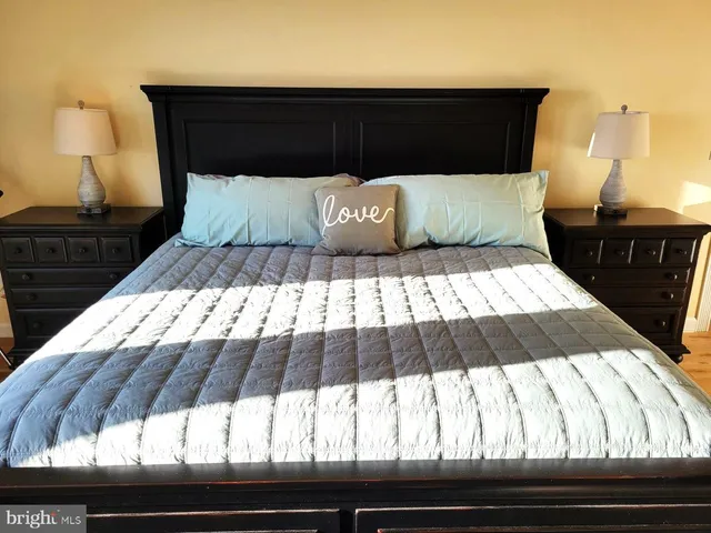 a bedroom with a bed and a night stand