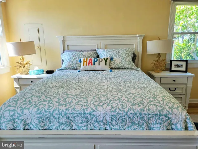 a bed sitting in a bedroom next to a window