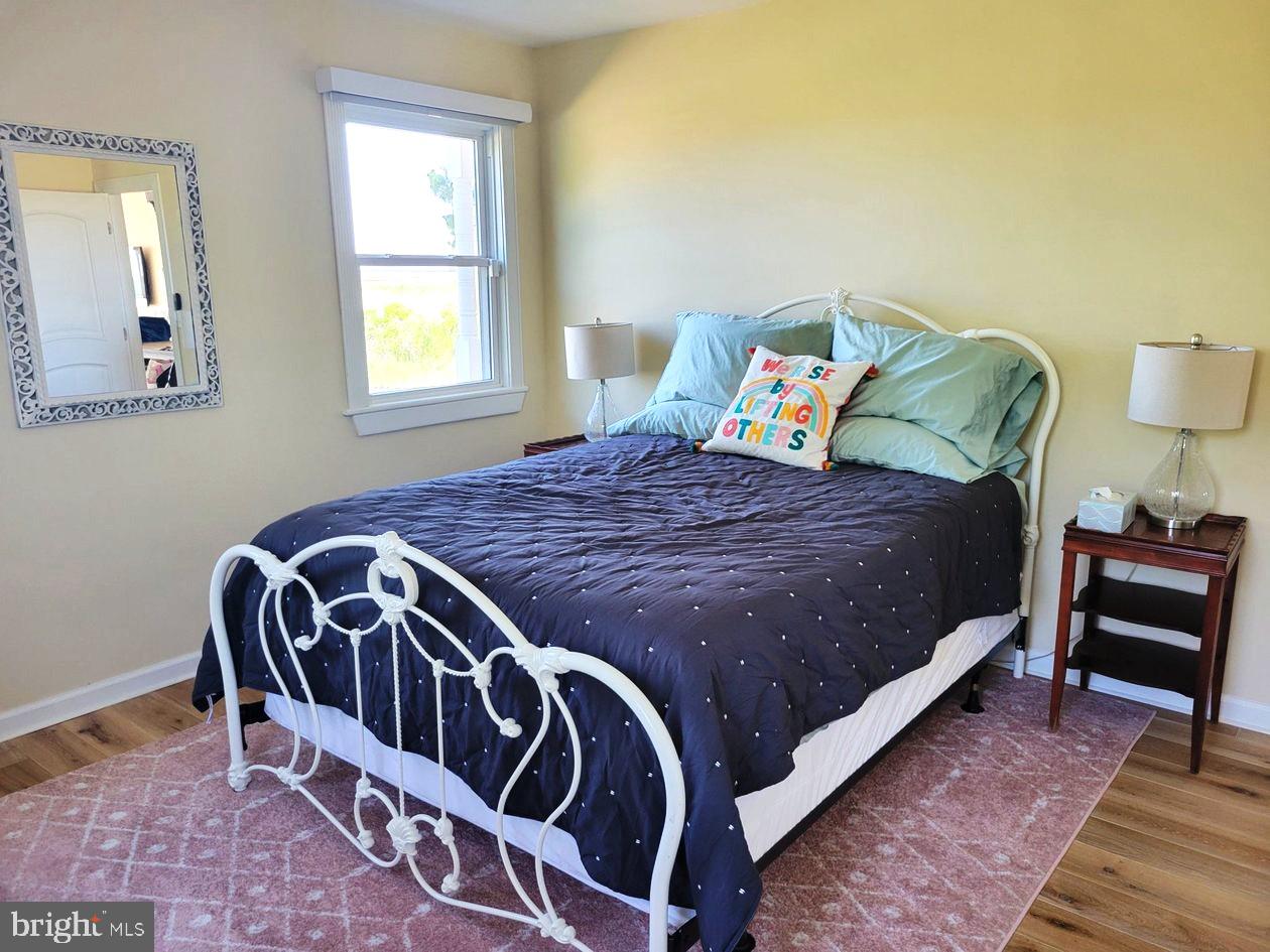 8034 Riverview Road Westover, MD 21871 - Photo 33 of 47 a bed sitting in a bedroom next to a window