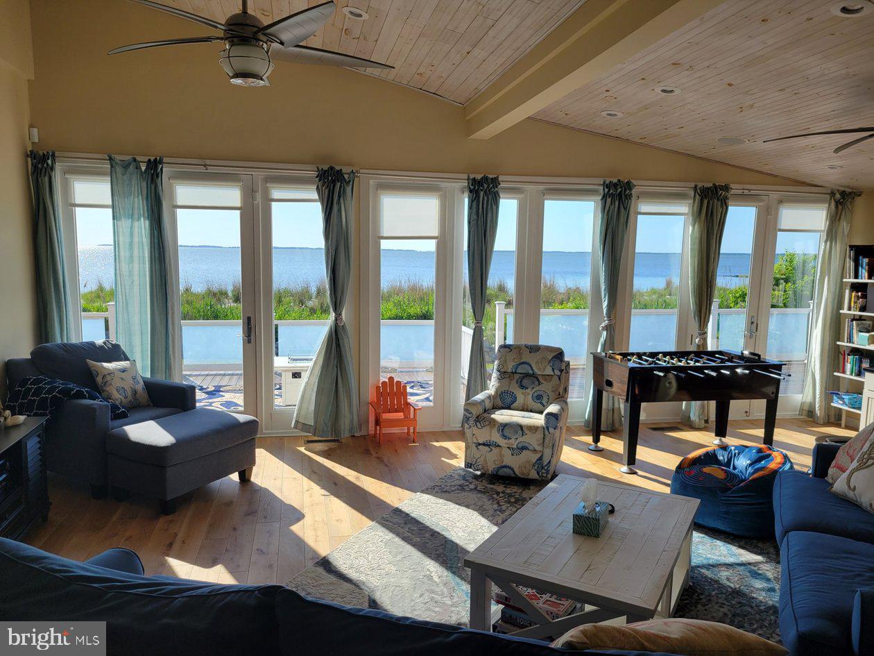 8034 Riverview Road Westover, MD 21871 - Photo 6 of 47 a living room with furniture and floor to ceiling windows