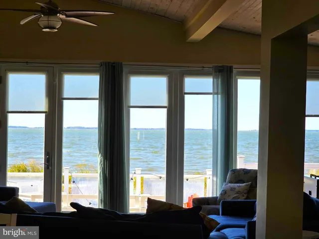 a view of living room with furniture and floor to ceiling window