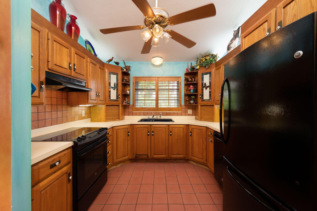 111 Windy Point Circle Marathon, FL 33050 - Photo 12 of 52 a kitchen with stainless steel appliances granite countertop a sink a stove and a refrigerator