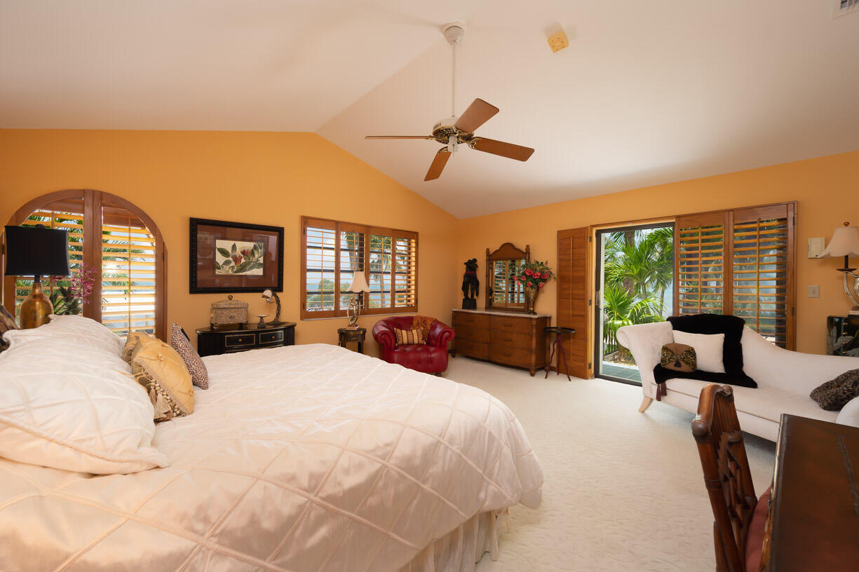 111 Windy Point Circle Marathon, FL 33050 - Photo 14 of 52 a large bedroom with a bed and large windows