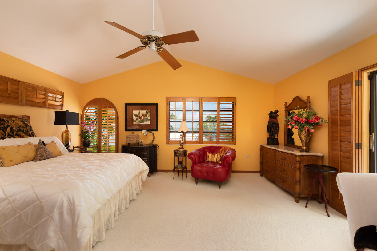 111 Windy Point Circle Marathon, FL 33050 - Photo 15 of 52 a bedroom with a bed and a chandelier