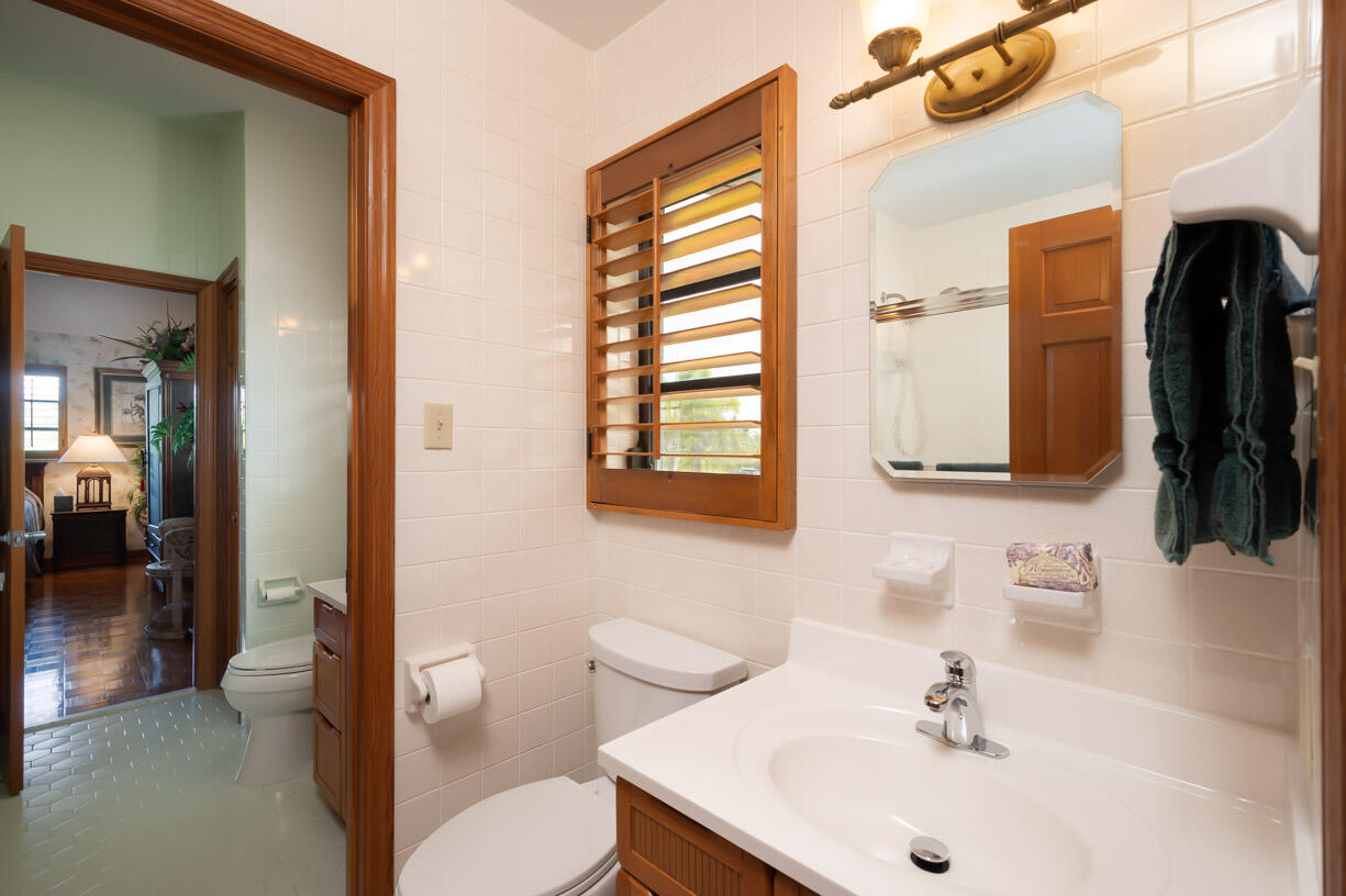 111 Windy Point Circle Marathon, FL 33050 - Photo 18 of 52 a bathroom with a sink a toilet and a mirror