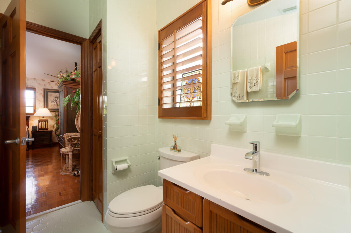 111 Windy Point Circle Marathon, FL 33050 - Photo 19 of 52 a bathroom with a sink a toilet and shower curtain