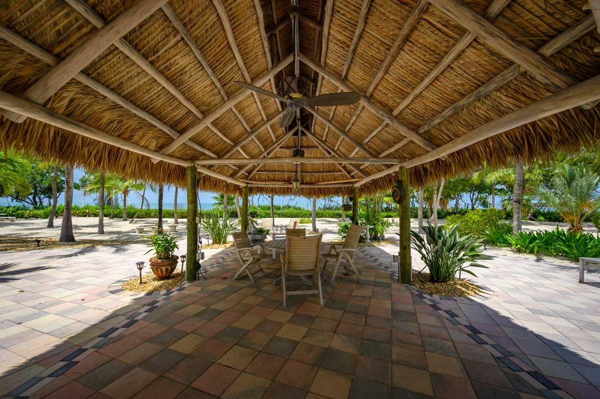 111 Windy Point Circle Marathon, FL 33050 - Photo 30 of 52 a view of a patio with table and chairs a barbeque with plants and trees