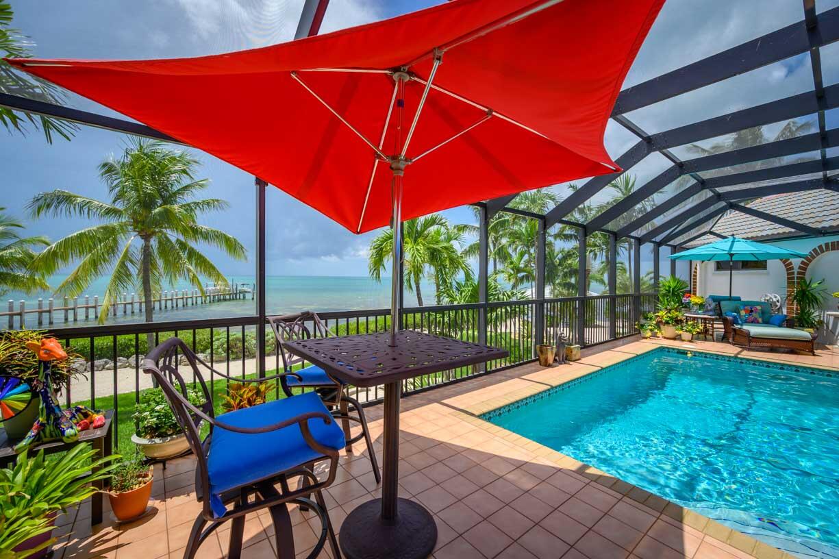 111 Windy Point Circle Marathon, FL 33050 - Photo 42 of 52 a patio with swimming pool table and chairs