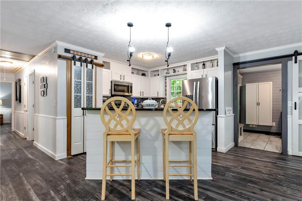 90 Old City Park Road Lavonia, GA 30553 - Photo 13 of 41 a view of a kitchen with refrigerator and wooden floor
