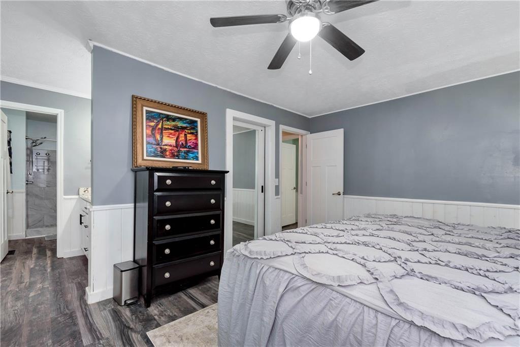 90 Old City Park Road Lavonia, GA 30553 - Photo 23 of 41 a bedroom with a bed and a chandelier