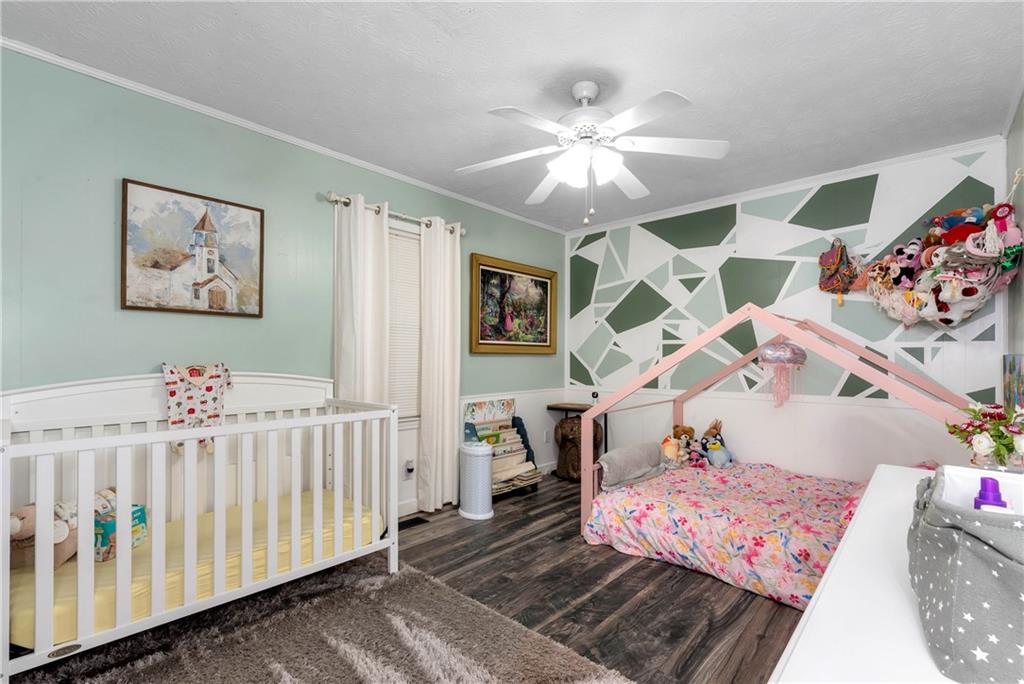 90 Old City Park Road Lavonia, GA 30553 - Photo 31 of 41 a bedroom with a bed and a chandelier