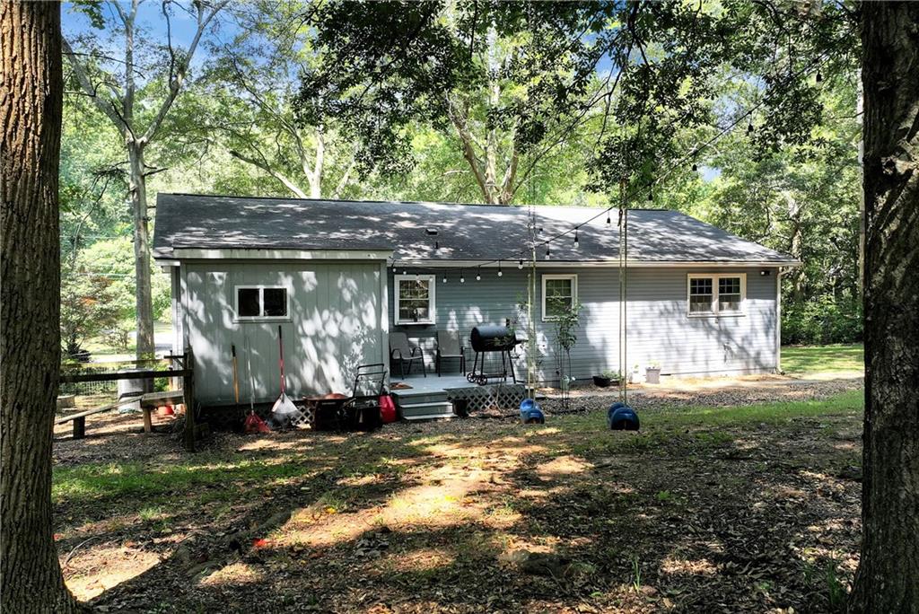90 Old City Park Road Lavonia, GA 30553 - Photo 37 of 41 a front view of a house with a garden and porch