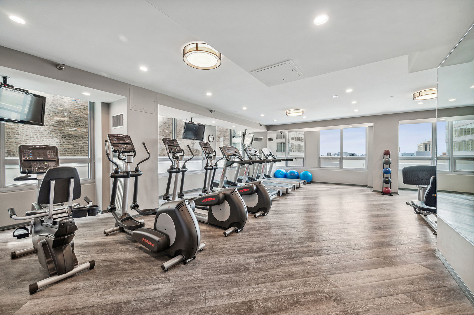 701 South Wells Street, Unit 903 Chicago, IL 60607 - Photo 20 of 20 a view of a room with gym equipment and large window