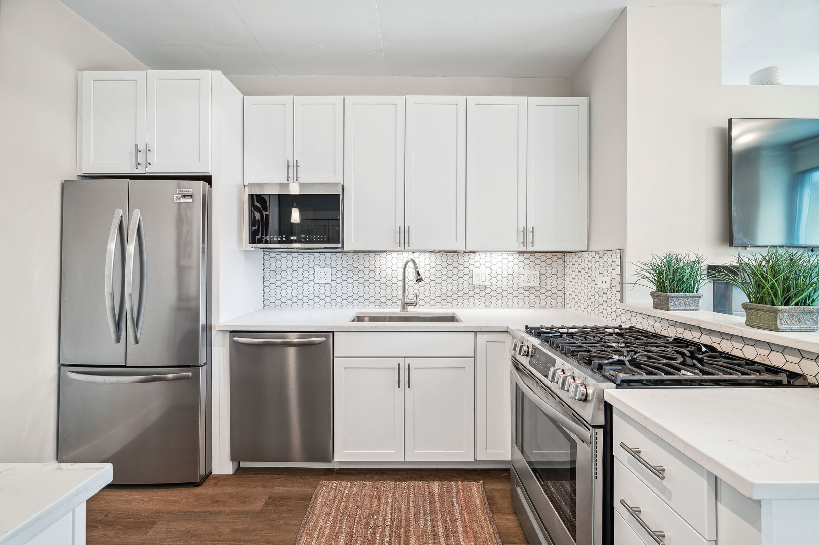 701 South Wells Street, Unit 903 Chicago, IL 60607 - Photo 9 of 20 a kitchen with a refrigerator stove and white cabinets