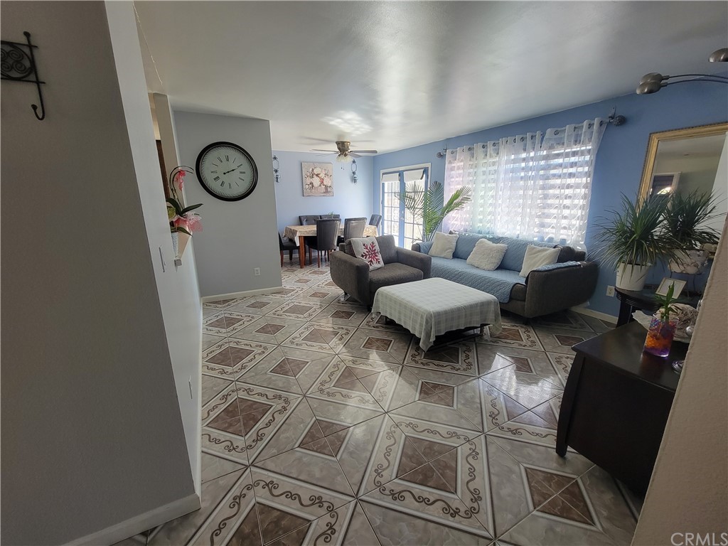 8381 Verde Ridge Road Spring Valley, CA 91977 - Photo 13 of 30 a living room with furniture a clock and a window