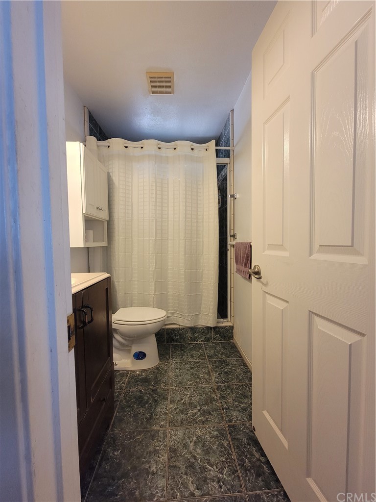 8381 Verde Ridge Road Spring Valley, CA 91977 - Photo 16 of 30 a bathroom with a sink a toilet a mirror and shower