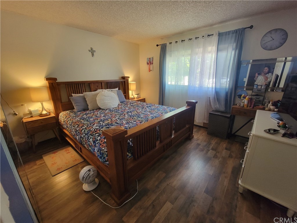 8381 Verde Ridge Road Spring Valley, CA 91977 - Photo 23 of 30 a bedroom with a bed and wooden floor