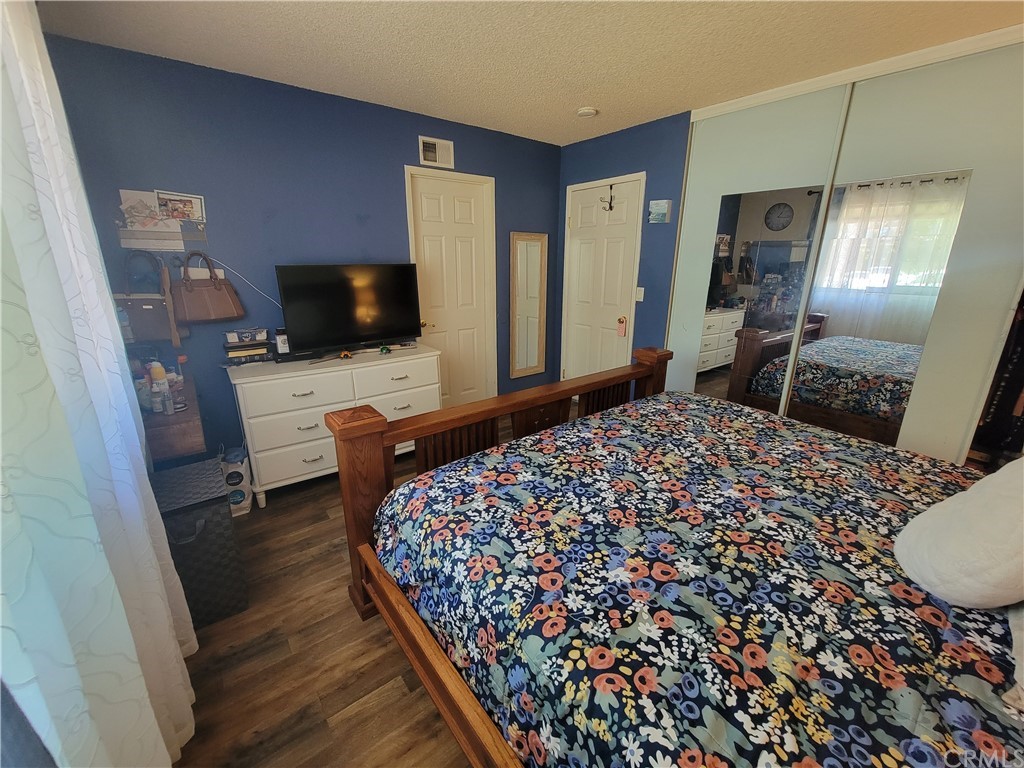 8381 Verde Ridge Road Spring Valley, CA 91977 - Photo 25 of 30 a bedroom with a bed and a television in it