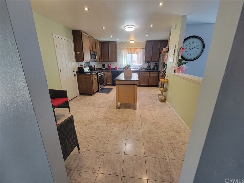 8381 Verde Ridge Road Spring Valley, CA 91977 - Photo 3 of 30 a living room with stainless steel appliances furniture a rug and a window