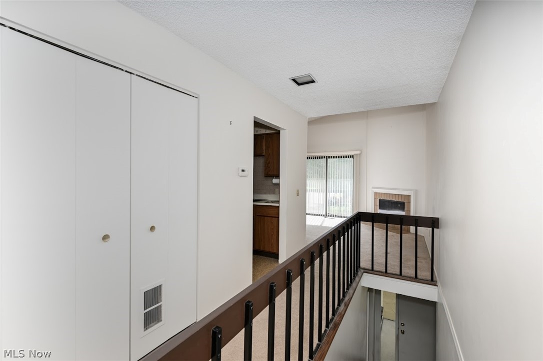 979 Hampton Ridge Drive Akron, OH 44313 - Photo 5 of 25 Hallway featuring a textured ceiling