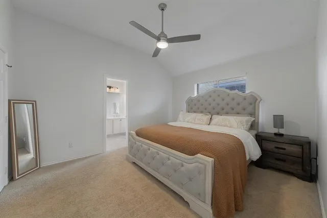 a bedroom with a bed and a ceiling fan