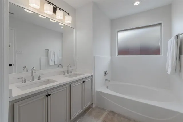 a bathroom with a bathtub a shower a sink and a mirror