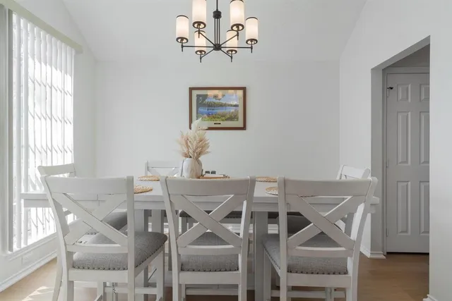 a view of a dining room with furniture and a chandelier