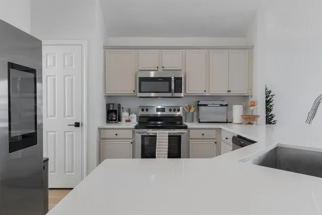 a kitchen with a refrigerator stove and microwave