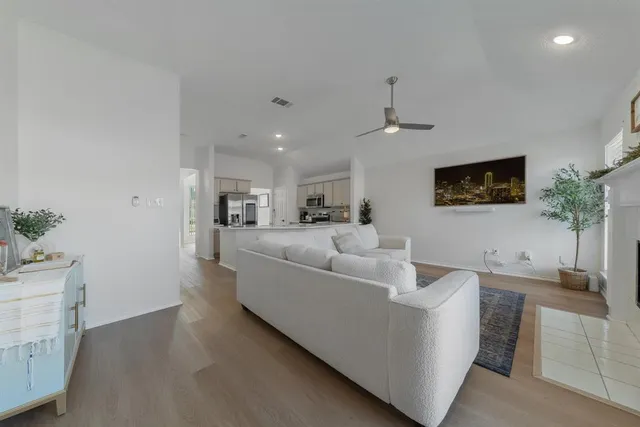 a living room with furniture and a potted plant