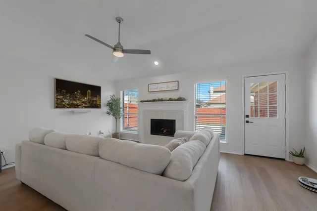 a living room with furniture a flat screen tv and a fireplace