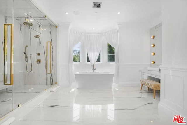 a spacious bathroom with a shower sink and mirror