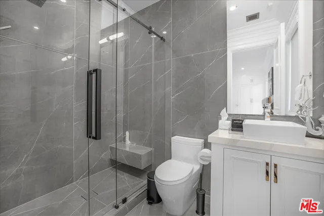 a white bed sitting in a bedroom next to a window