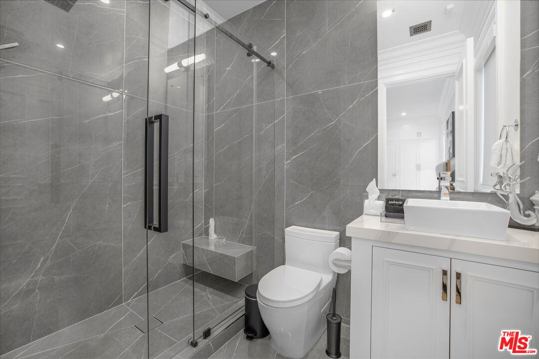 843 North Spaulding Avenue Los Angeles, CA 90046 - Photo 17 of 24 a bathroom with a sink toilet and shower