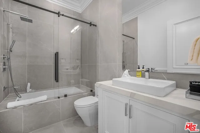 a bedroom with a bed and a night stand