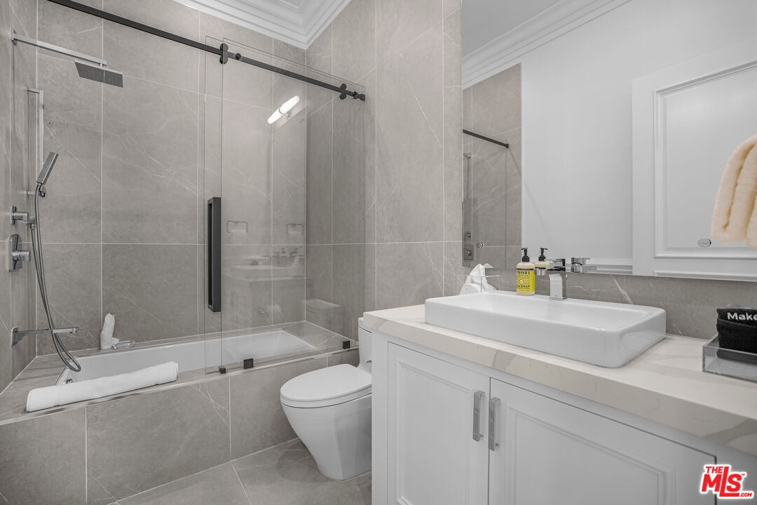 843 North Spaulding Avenue Los Angeles, CA 90046 - Photo 19 of 24 a bathroom with a sink a toilet and shower