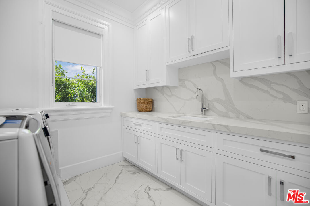843 North Spaulding Avenue Los Angeles, CA 90046 - Photo 21 of 24 a kitchen with white cabinets and window