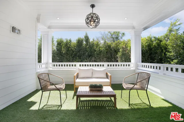 a view of a patio with table and chairs and potted plants