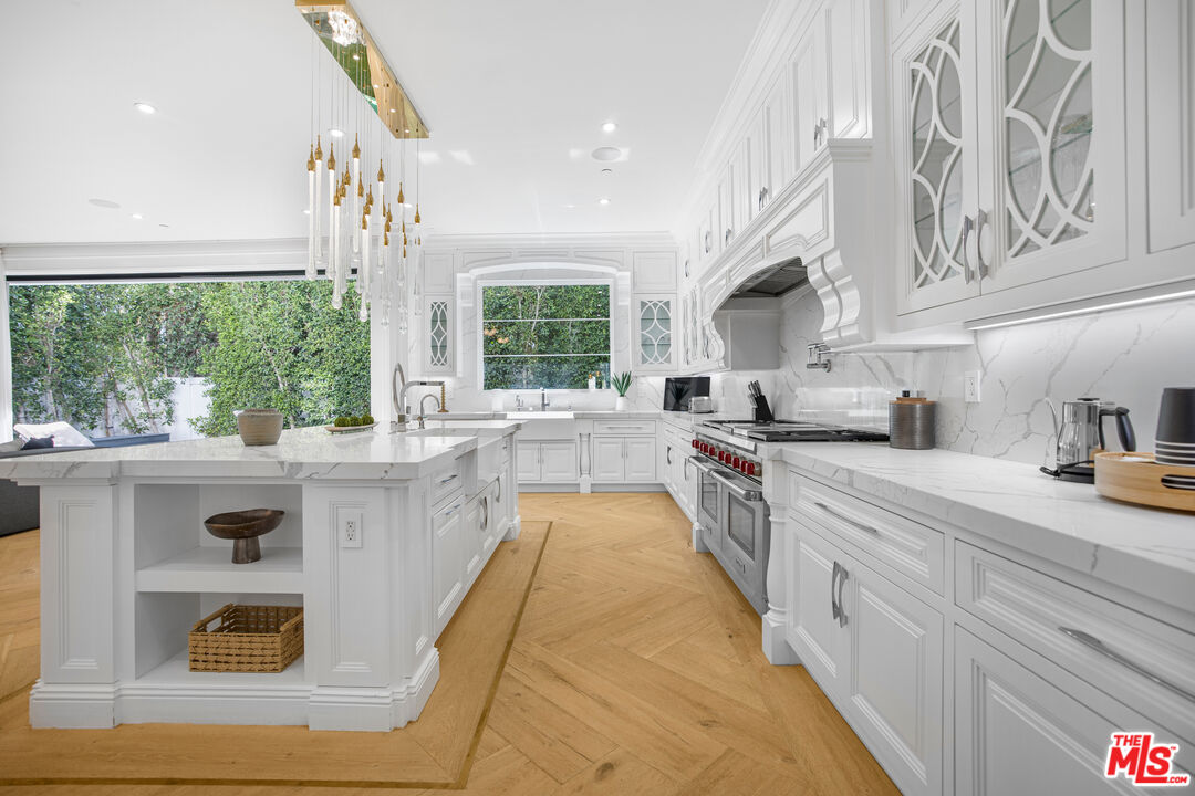 843 North Spaulding Avenue Los Angeles, CA 90046 - Photo 6 of 24 a large kitchen with stainless steel appliances granite countertop a stove a sink and a refrigerator