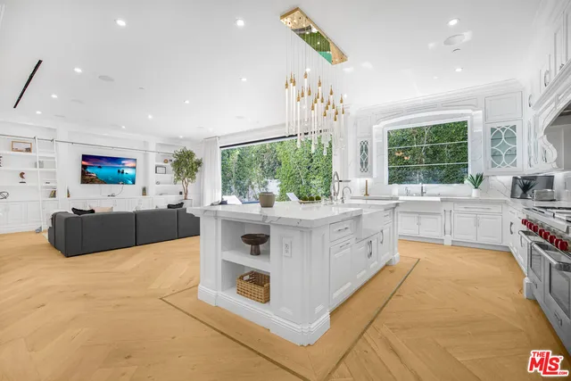 a large white kitchen with a large window