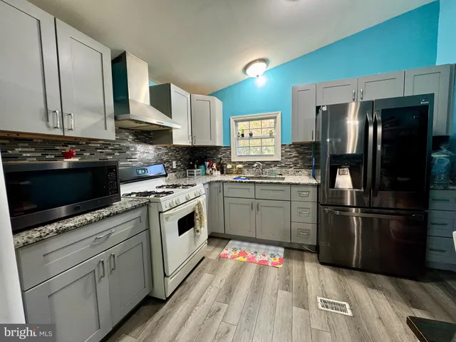 a kitchen with a sink stove and refrigerator