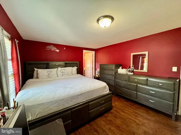 a bedroom with a bed and a dresser